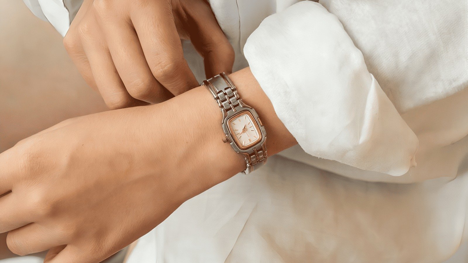 A vintage two-tone bracelet watch worn on the wrist